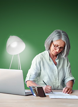 An old woman sitting on a table, writing her electricity bills with the spodelitok green backgrond a a lamp on the table